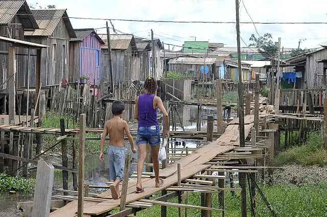 Em meio à falta de saneamento, moradores equilibram-se em ruas de madeira para chegar a suas casas, em Altamira, Pará | Foto: Wikimedia Commons